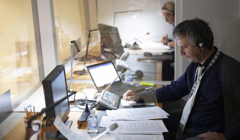 An interpreter at work at UNHQ. UN Photo/Evan Schneider