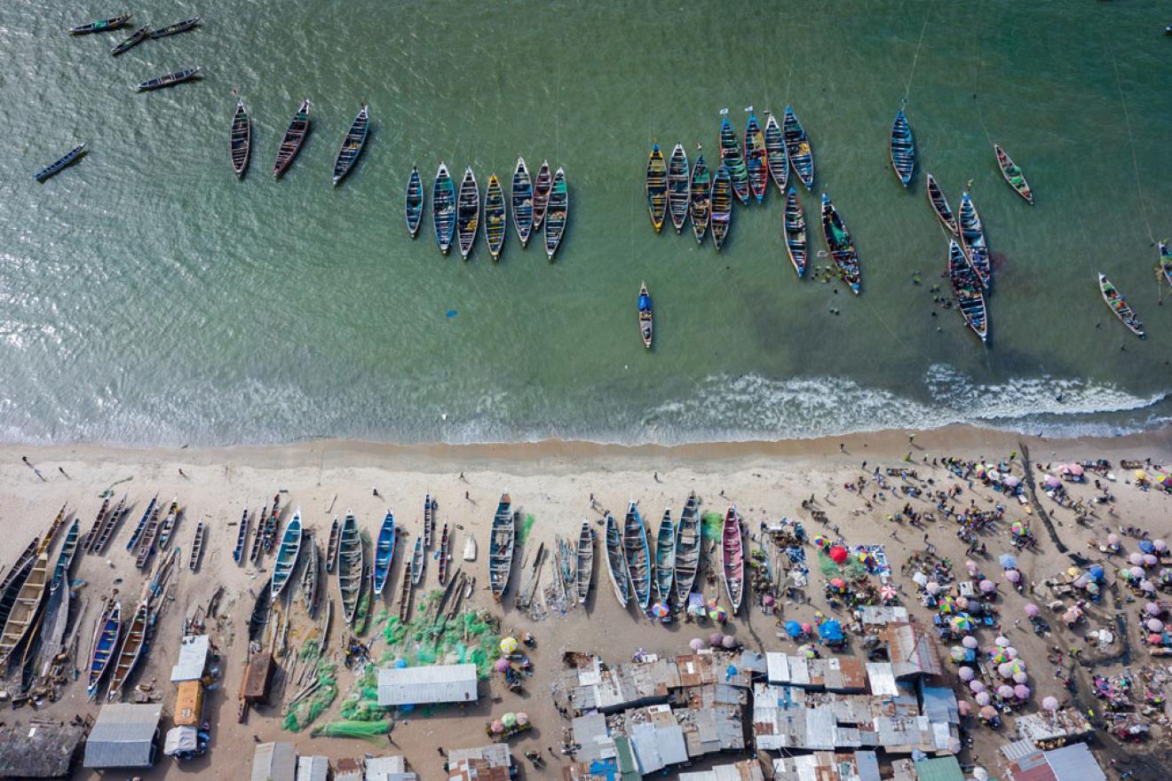 A shoreline lined with boats.